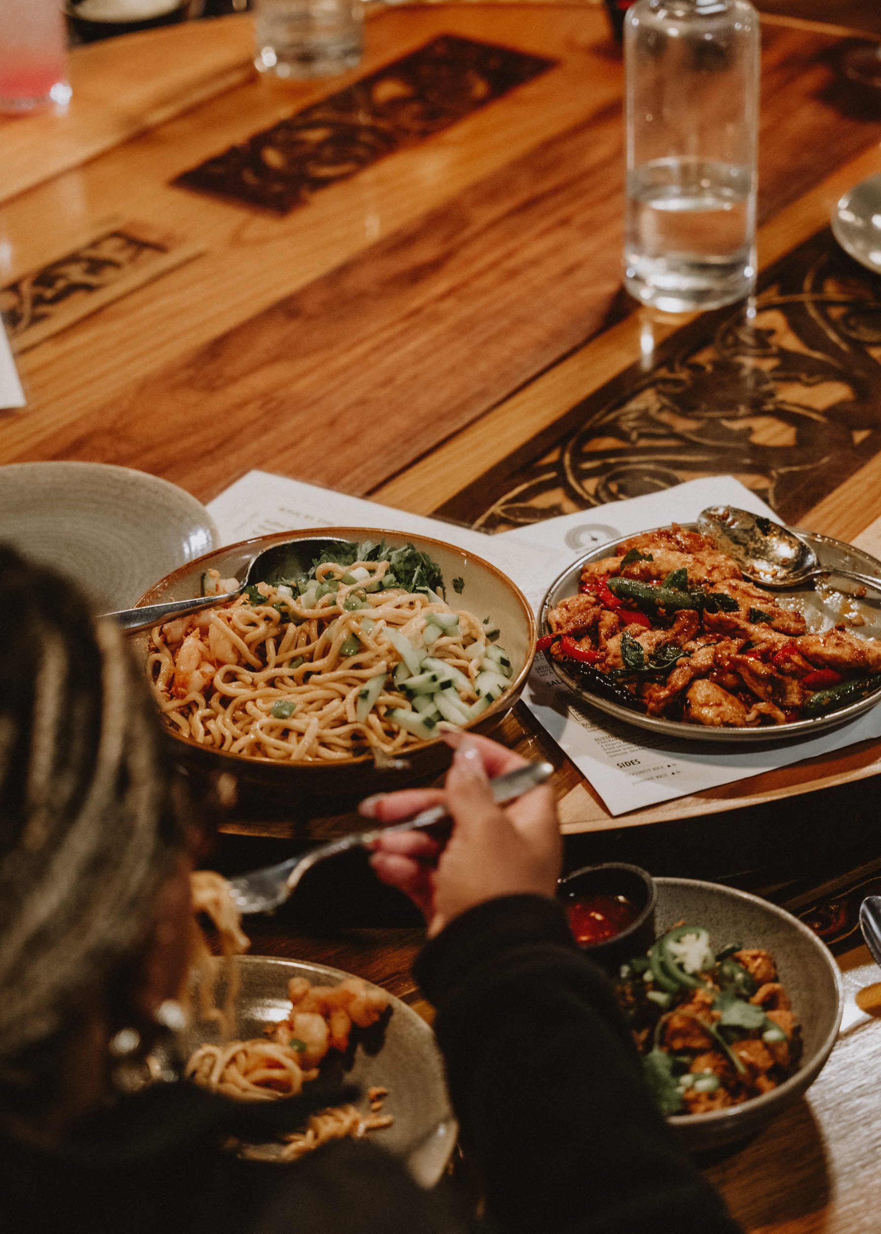 A long table of friends and dishes