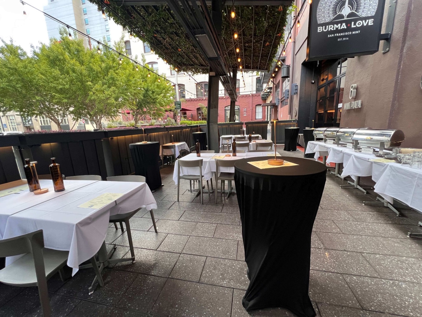 Full Buyout — patio set with high-tops, banquet tables, and chef stations