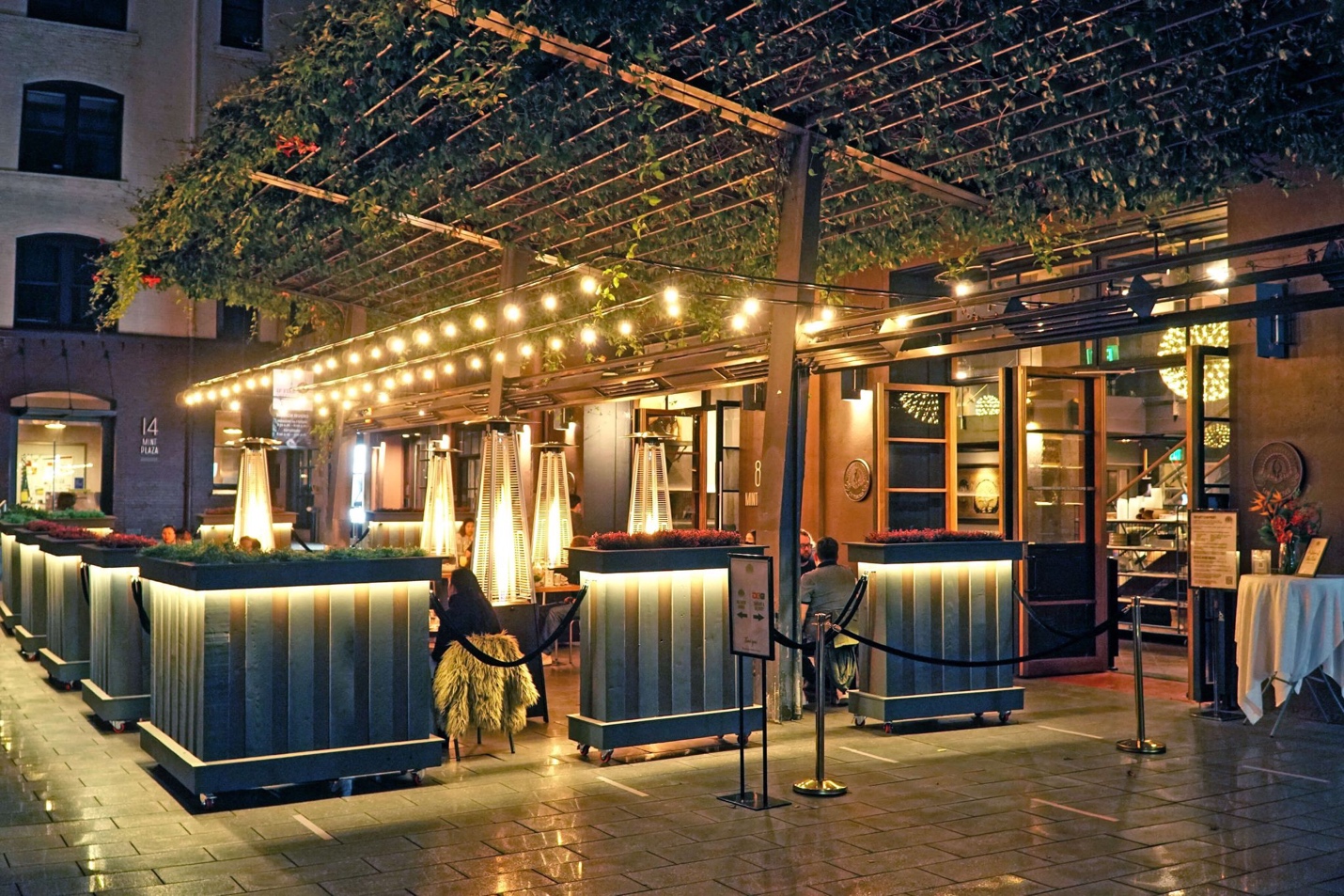 Outdoor Patio at Mint Plaza — string lights and vine-covered pergola