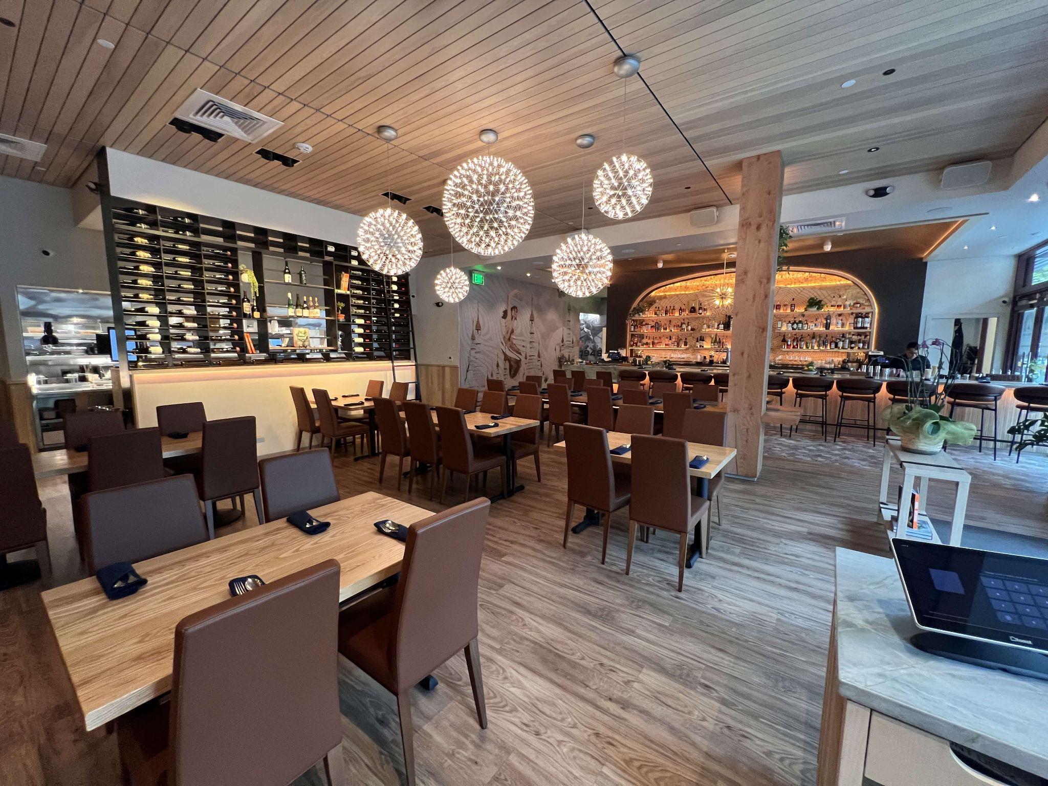 Burma Love Menlo Park — full dining room with firework chandeliers, bar, and arched backlit shelves