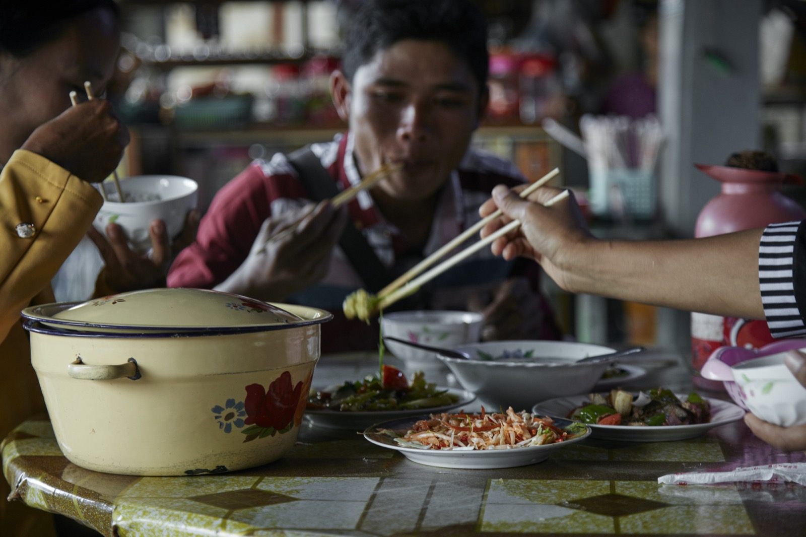 A Burmese family sharing a meal around the table